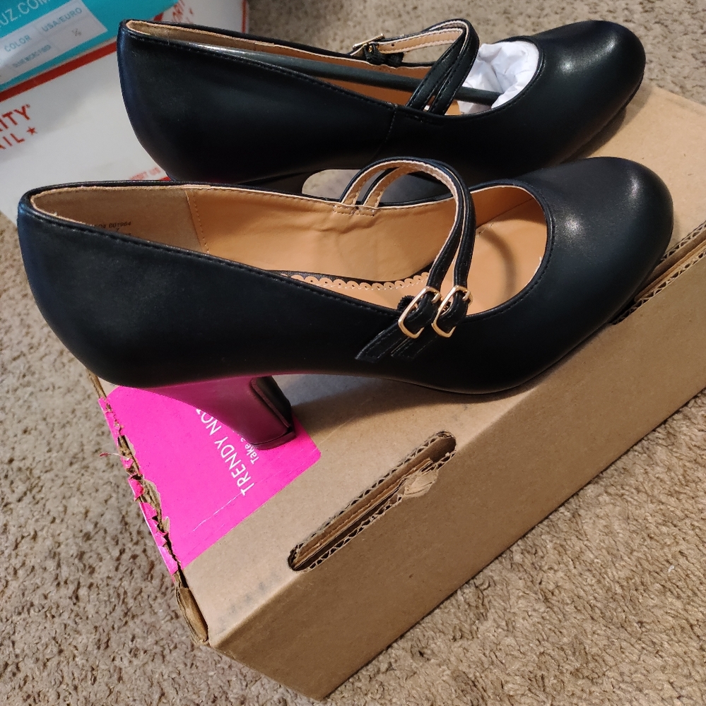 Black heals brand new with box.